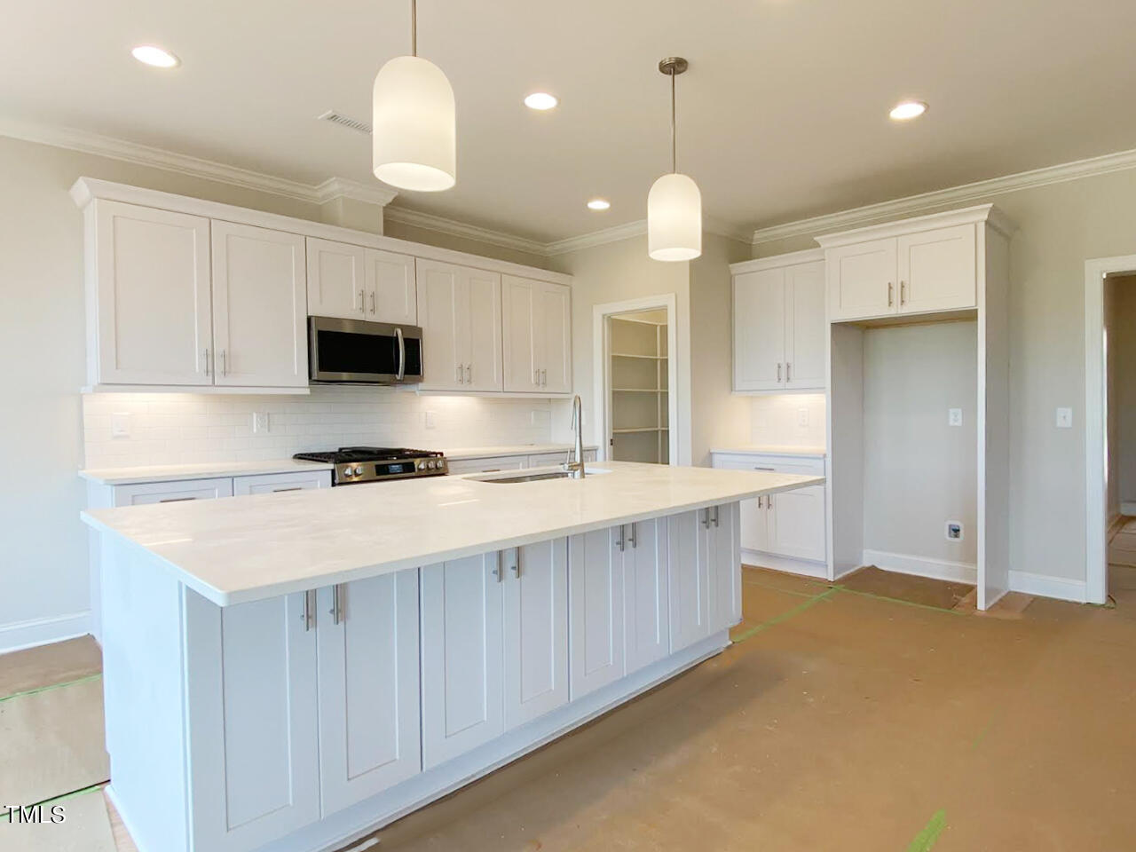 a large kitchen with kitchen island granite countertop a stove a sink a refrigerator and a center island