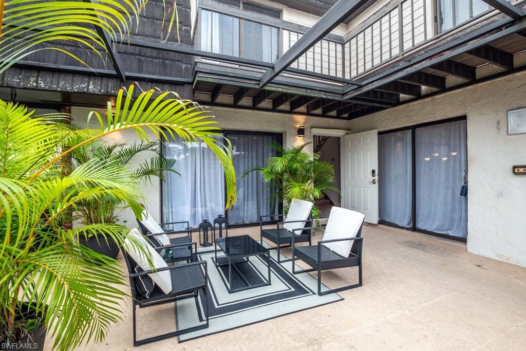 a view of a chairs and table in the balcony