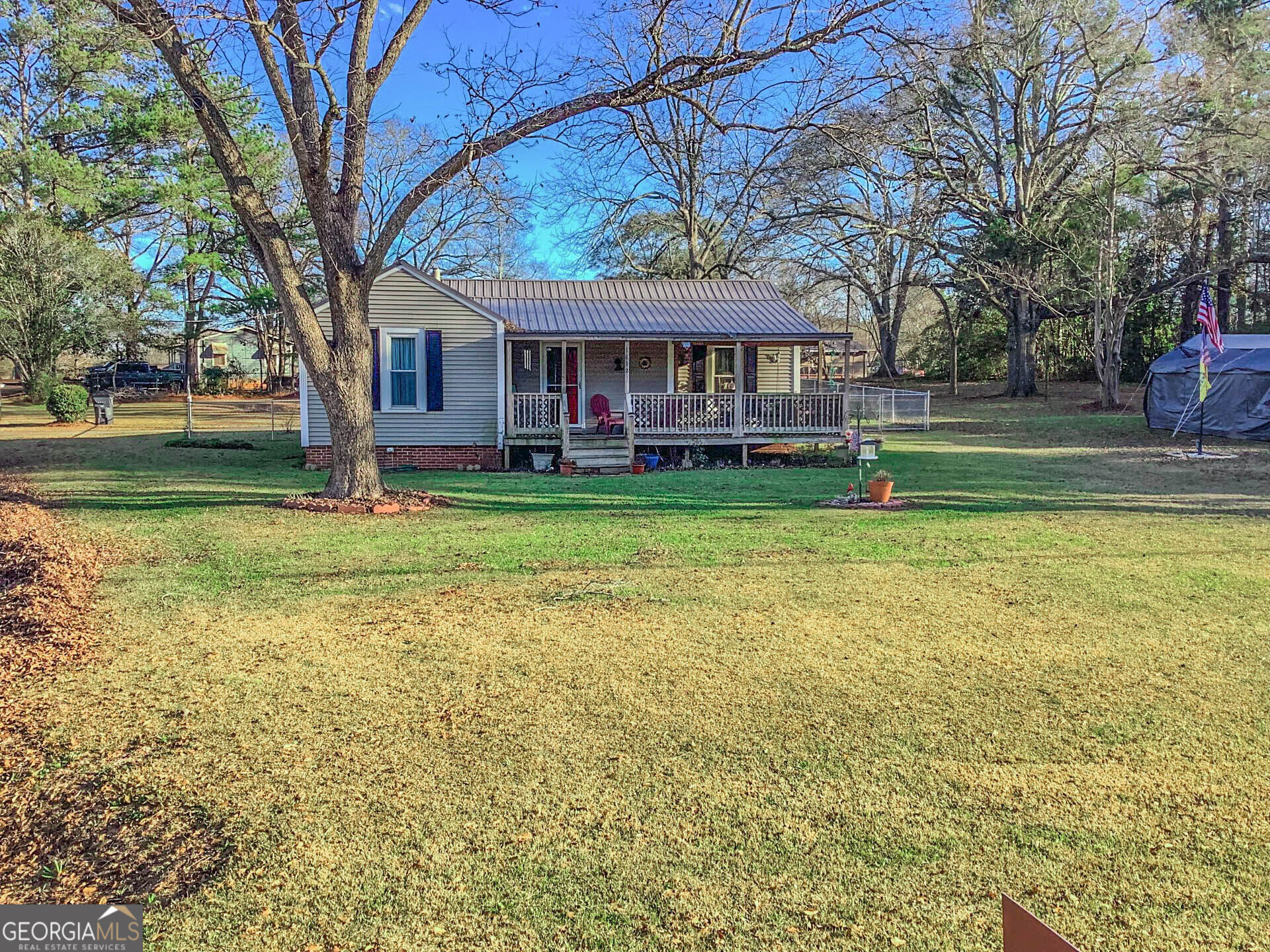 a view of a house with a yard and sitting area