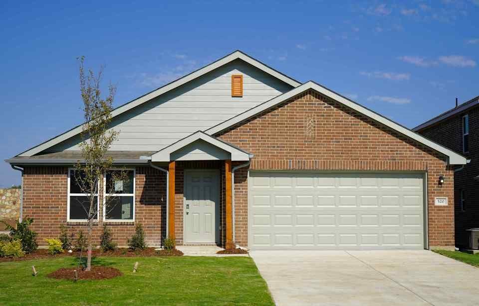 a front view of a house with a yard