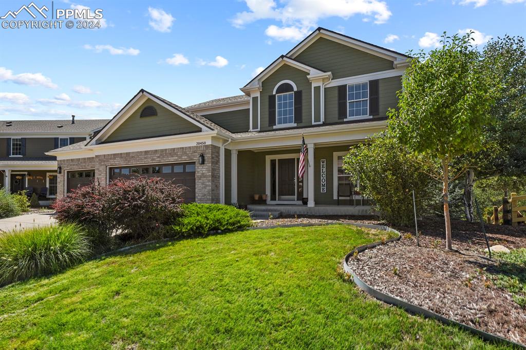 a front view of a house with garden