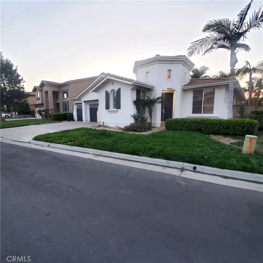 a front view of a house with a garden and garage