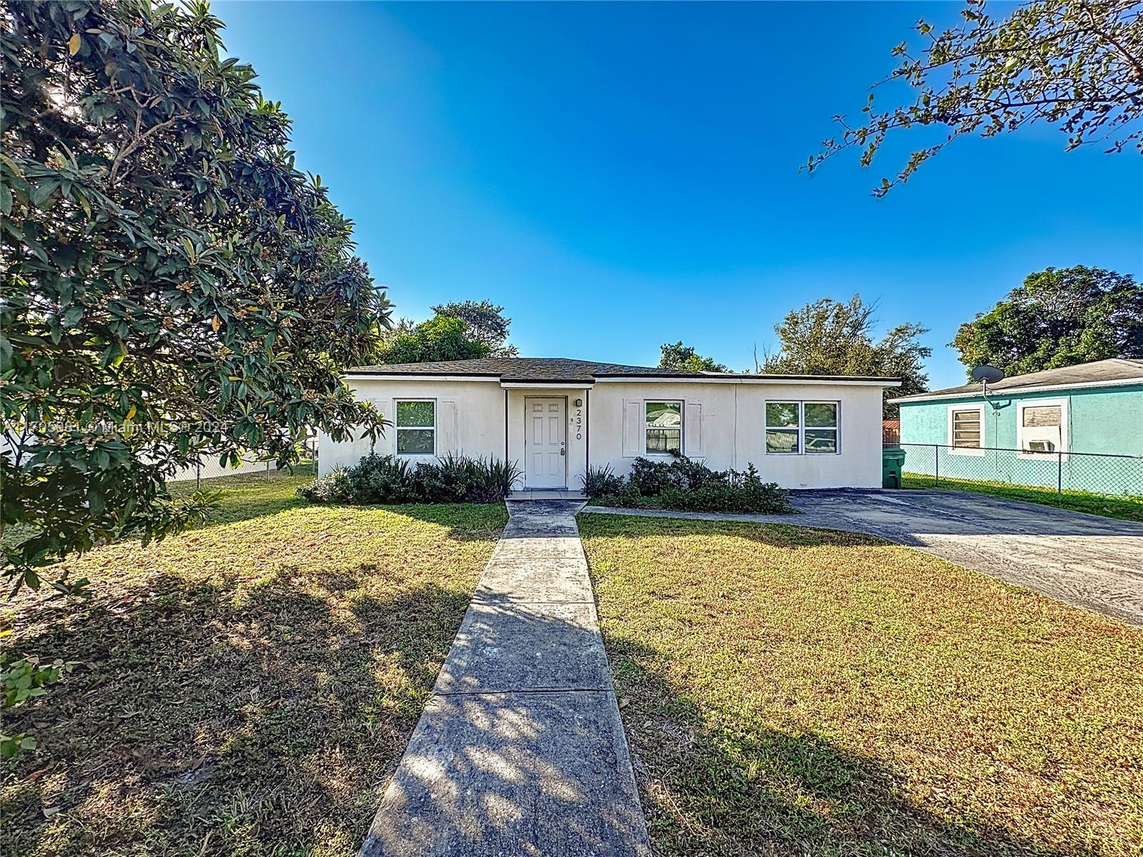 a front view of a house with a yard and porch