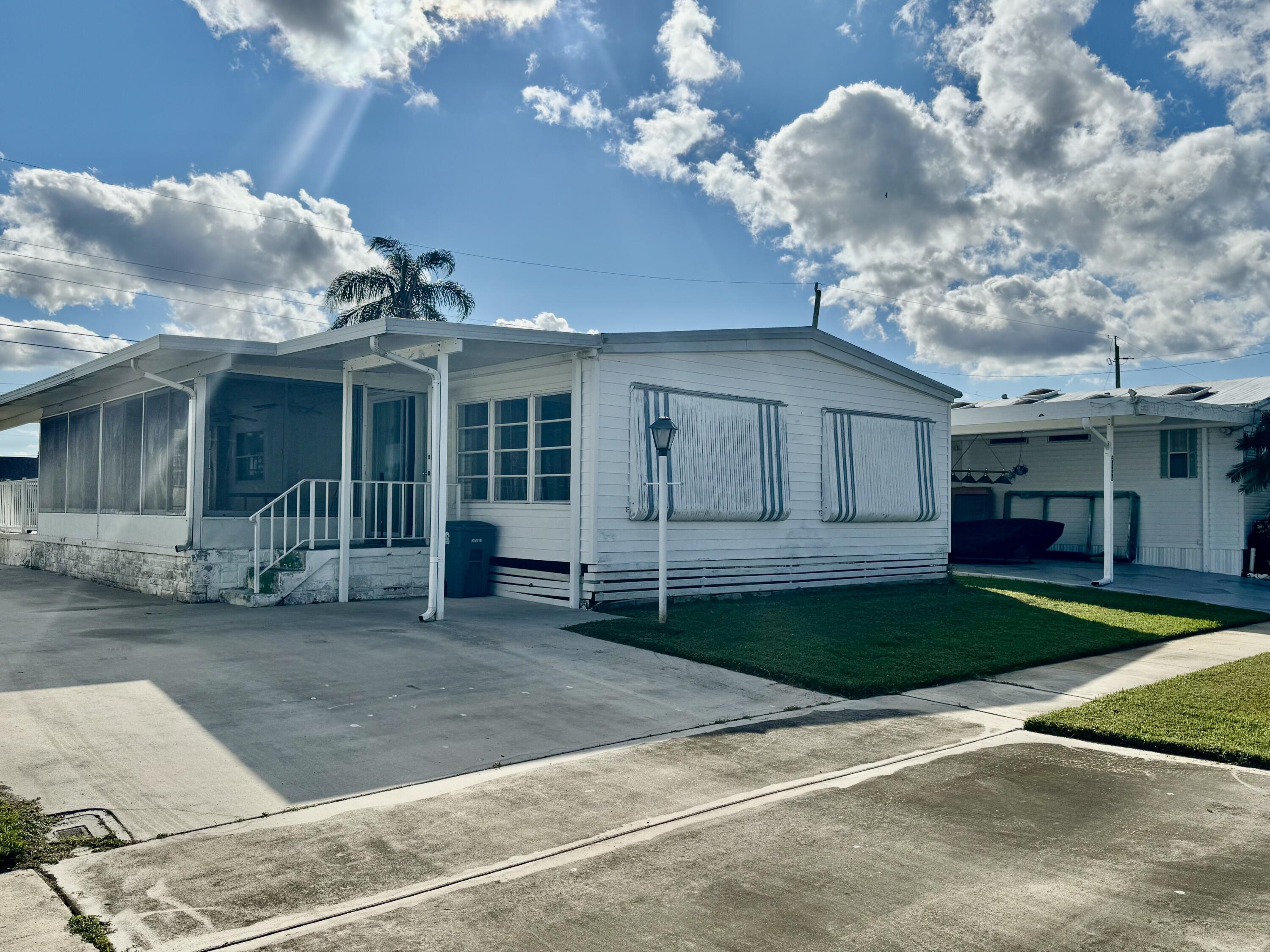 a view of a house with a yard and a garage