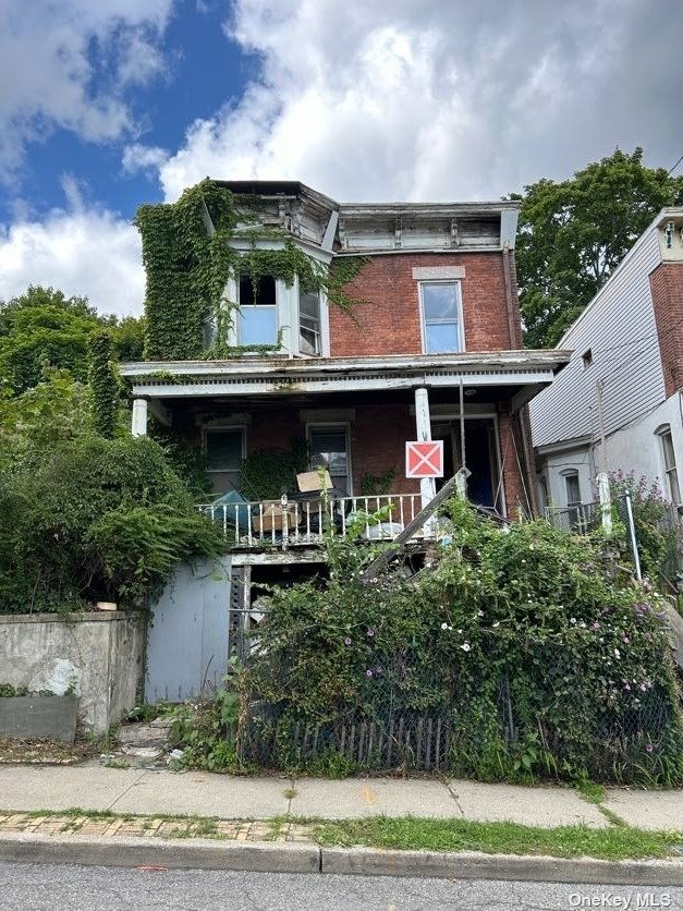 a front view of house with yard and trees around