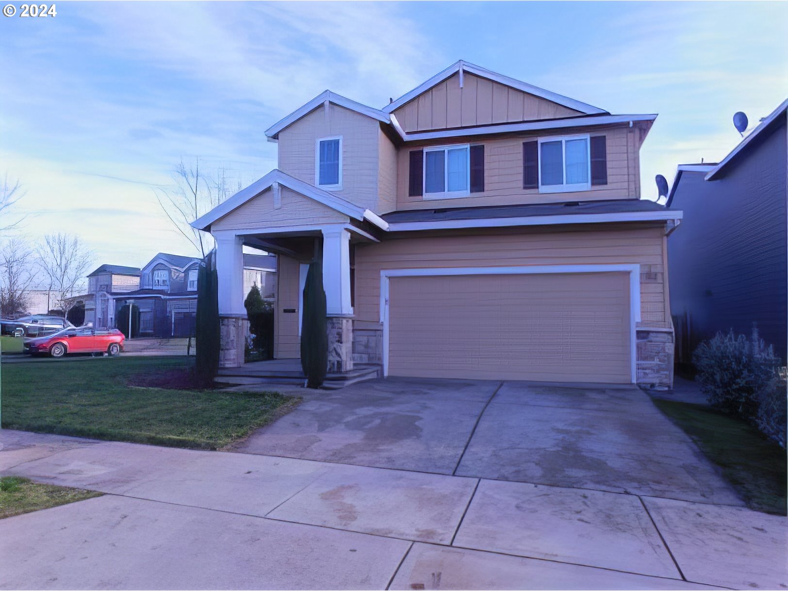 a front view of a house with a yard and garage