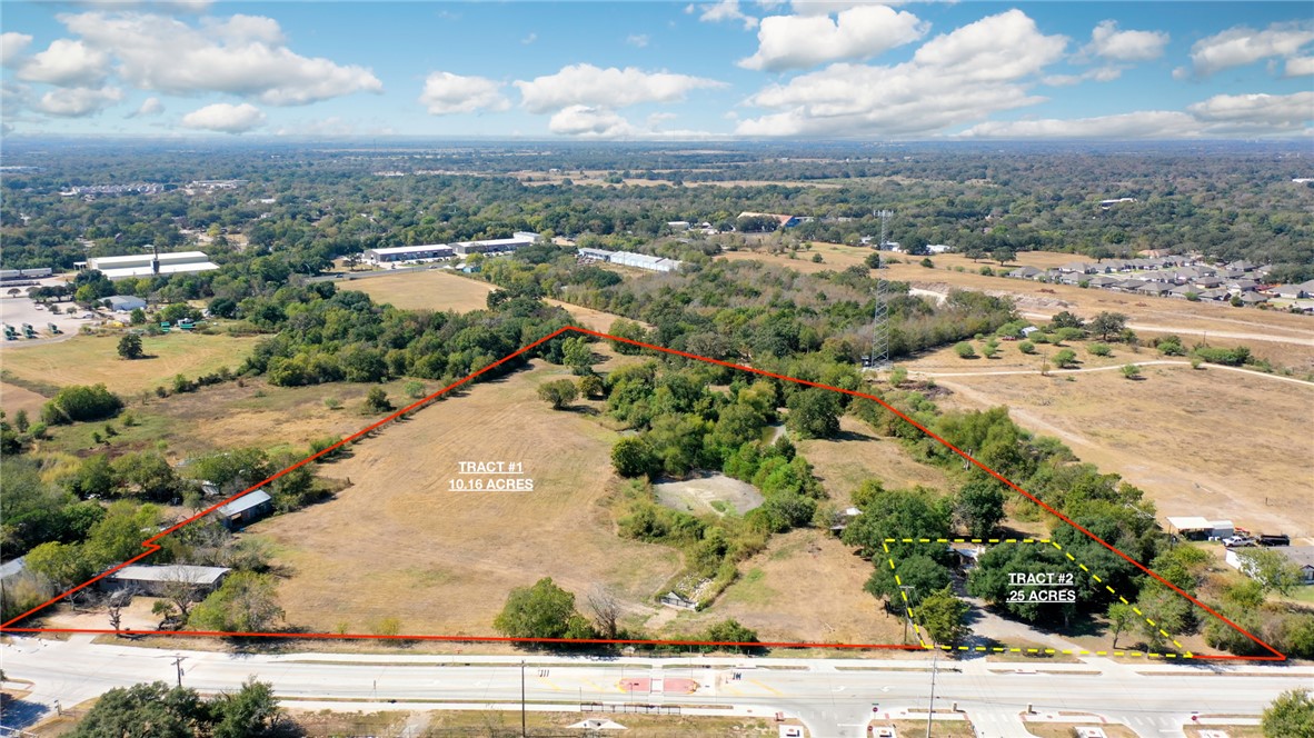 an aerial view of residential building with yard and parking