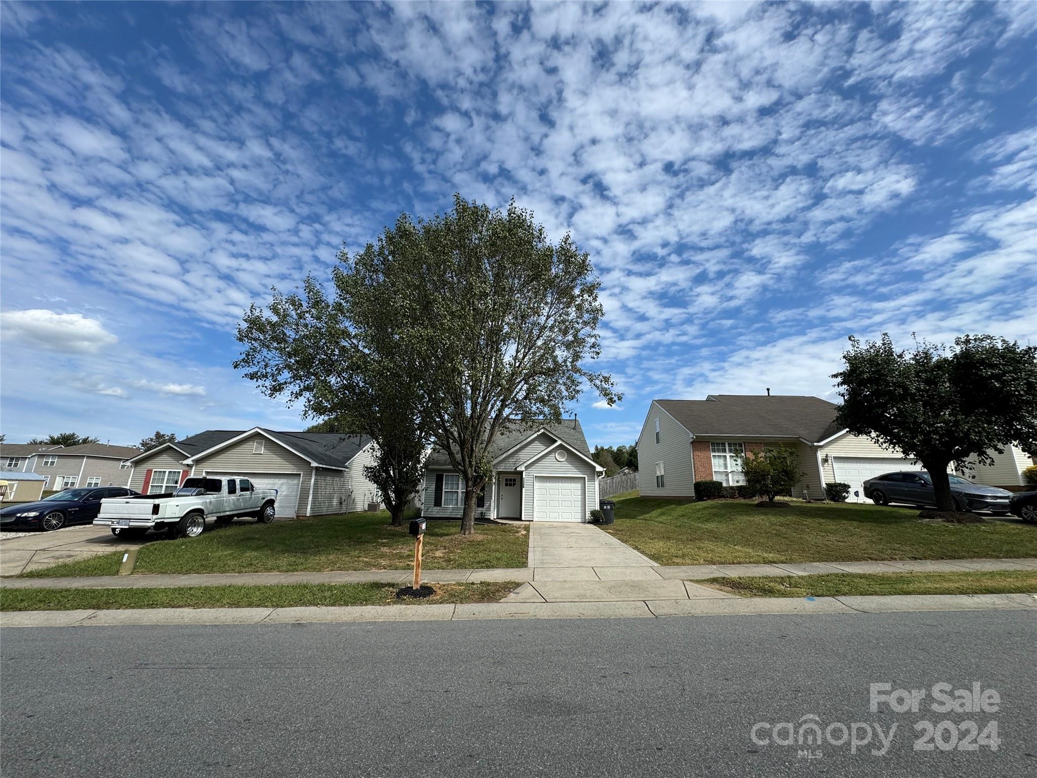 a view of street with houses and car parked