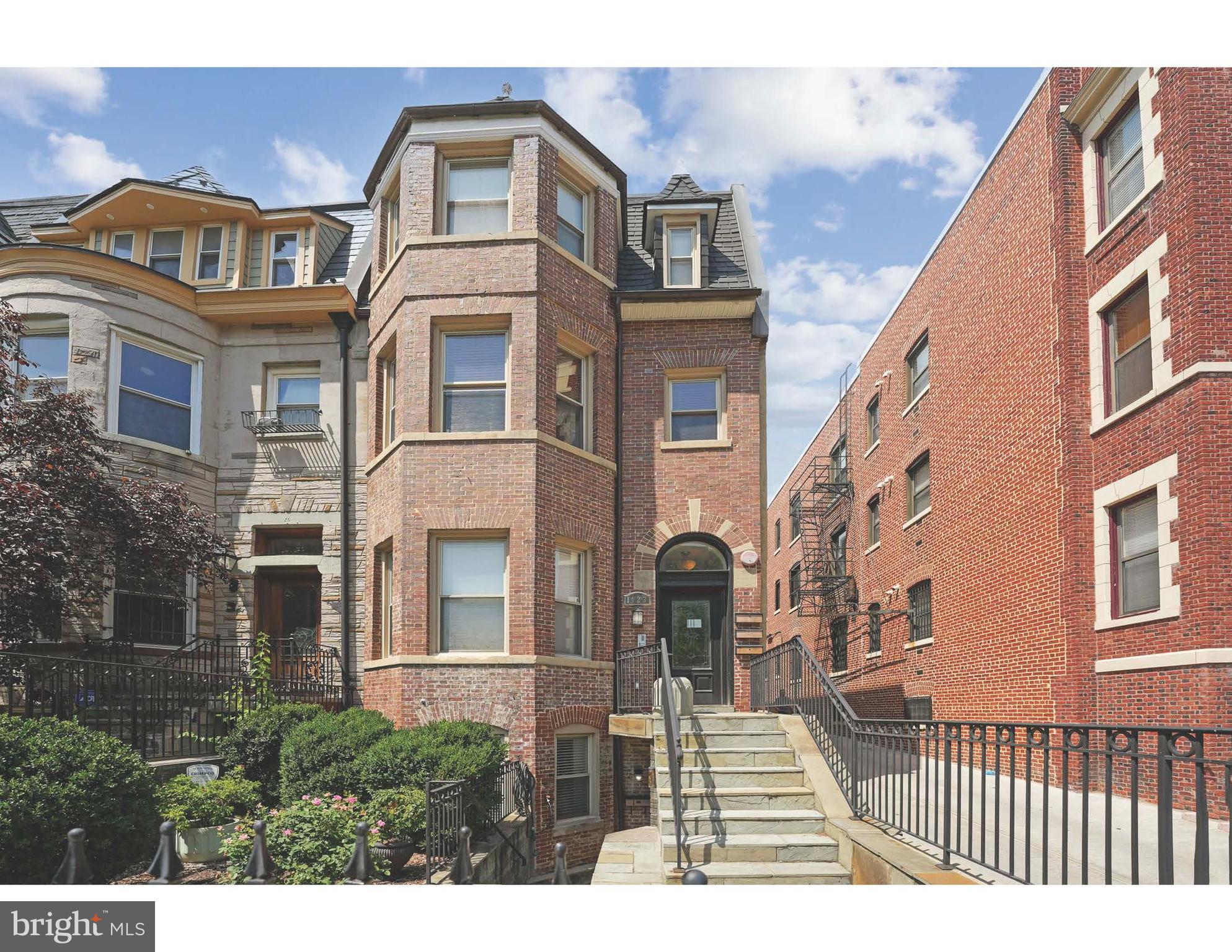 a view of a brick building next to a yard