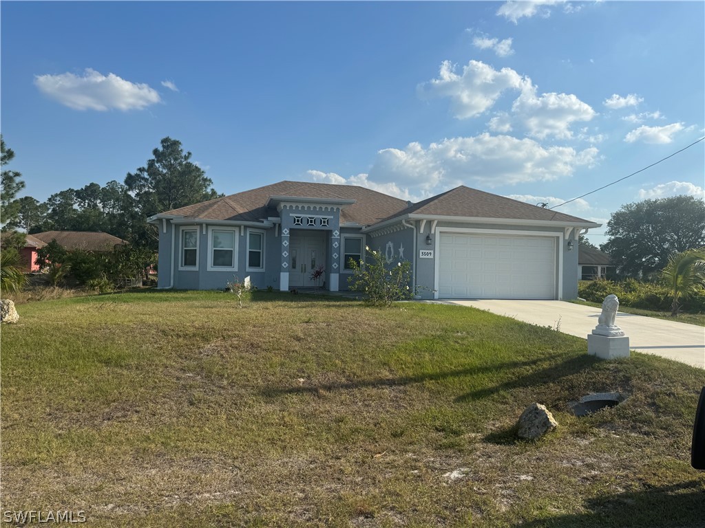 a view of a house with backyard and sitting area