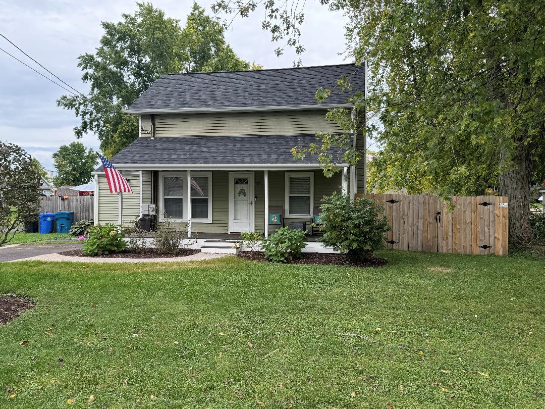 a front view of a house with a yard and porch