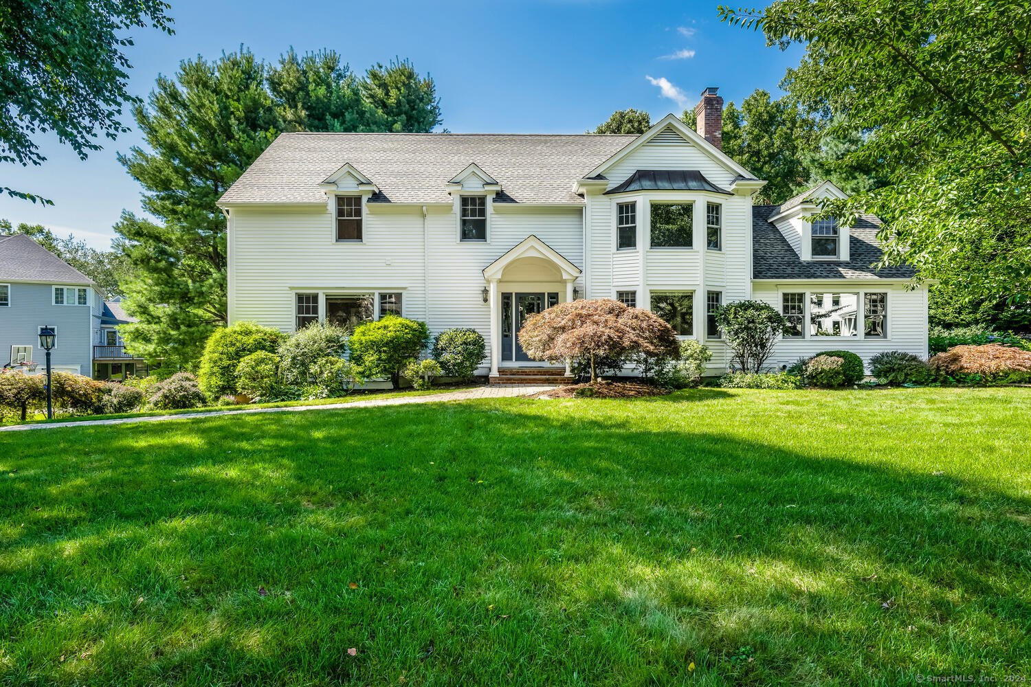 a front view of a house with a garden