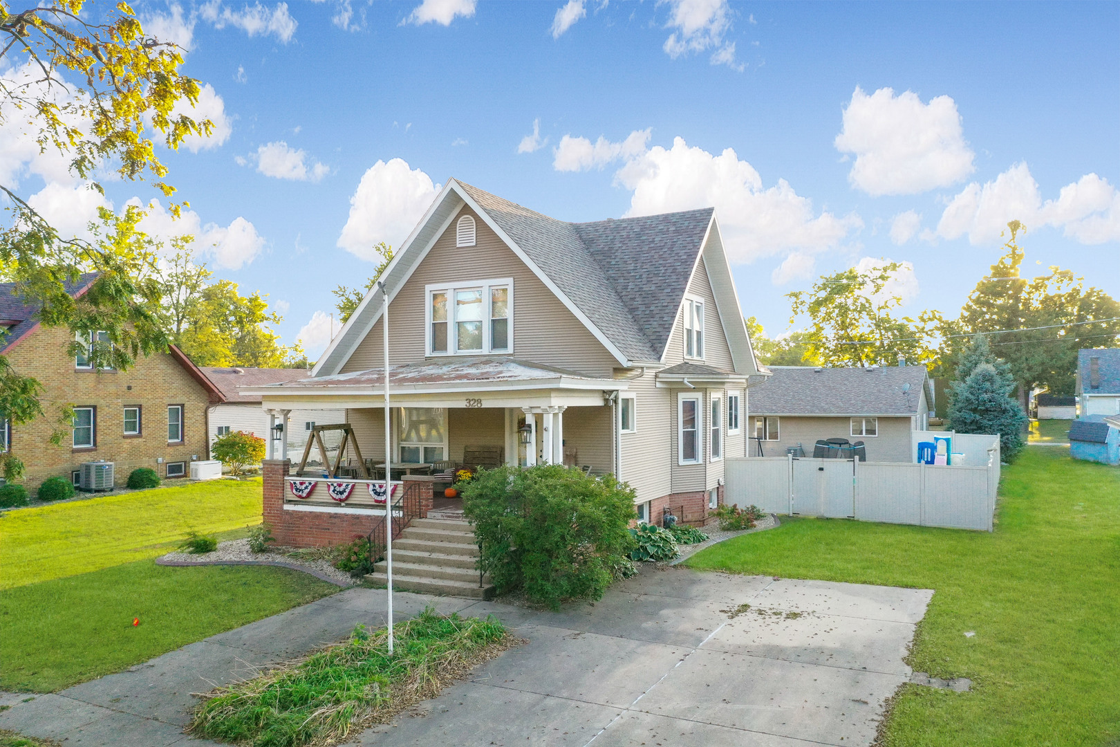 a front view of a house with a garden and yard