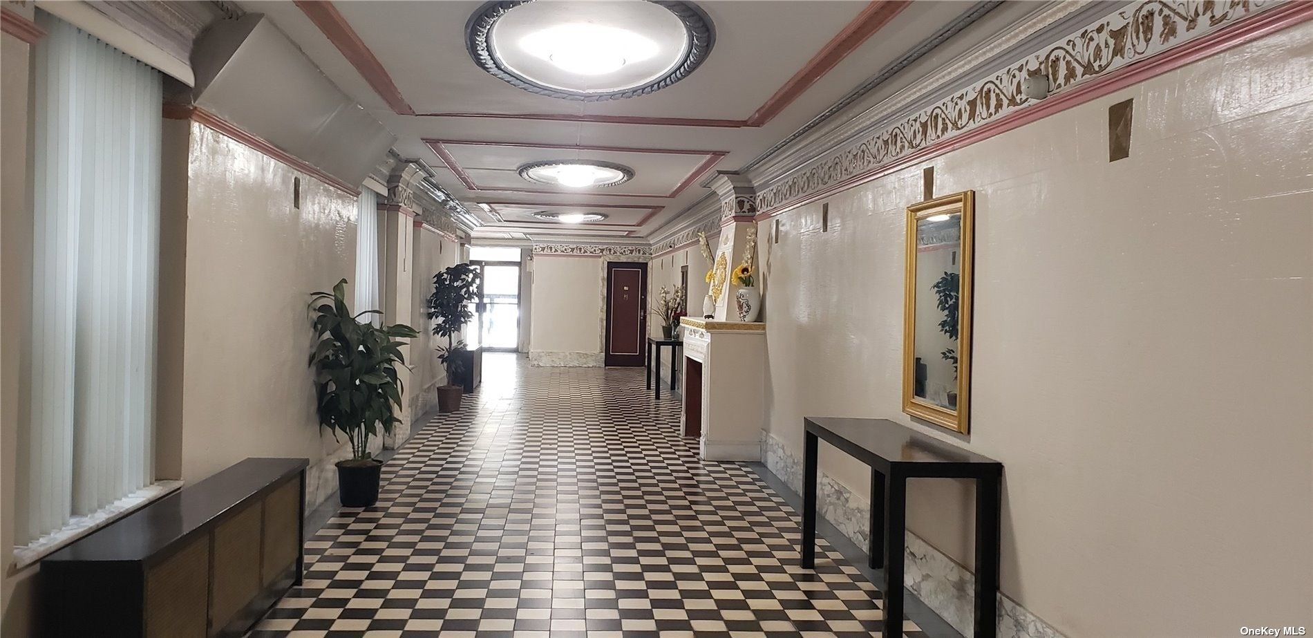 a view of a hallway with wooden floor and a living room