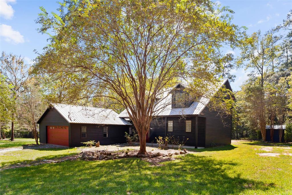 a large tree in front of house with yard