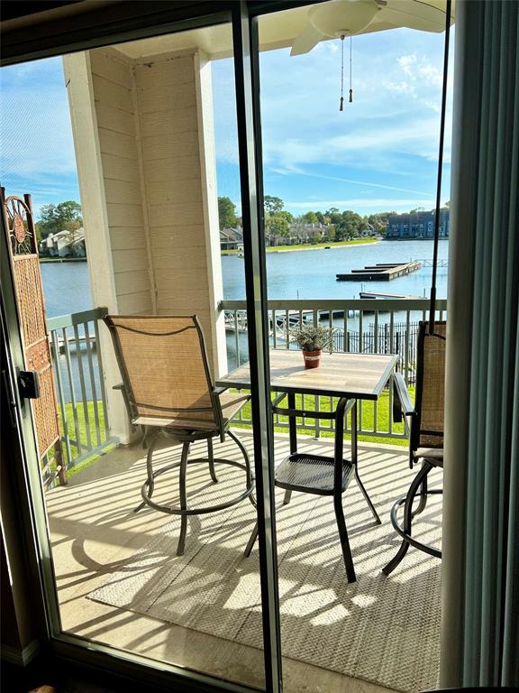 a view of a balcony with chairs and wooden floor