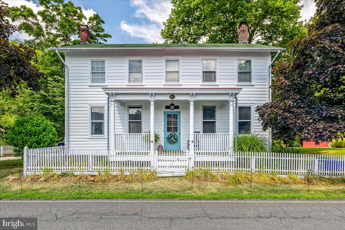 a house that has a tree in front of it