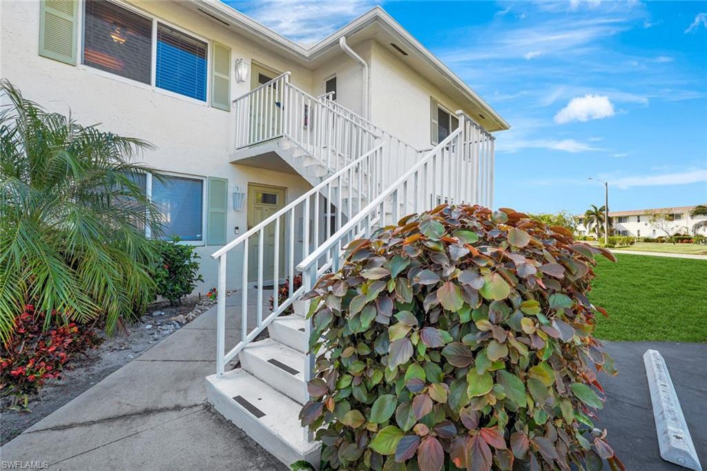 a view of a house with wooden fence