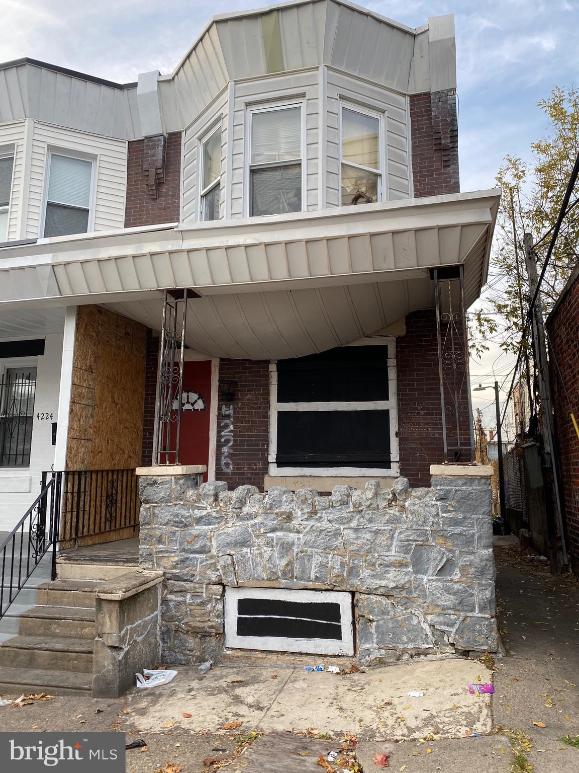 a front view of house with car parked