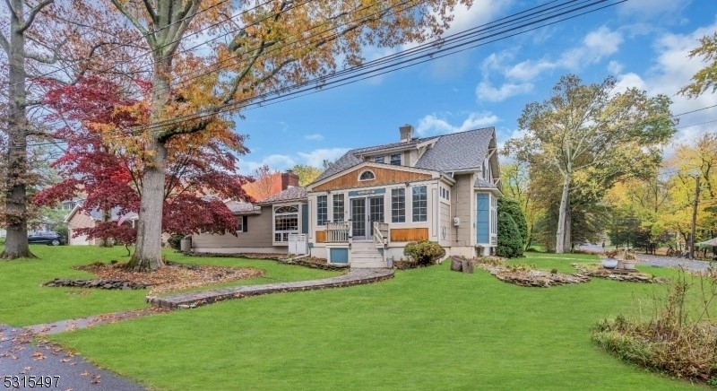 a front view of a house with a yard table and chairs