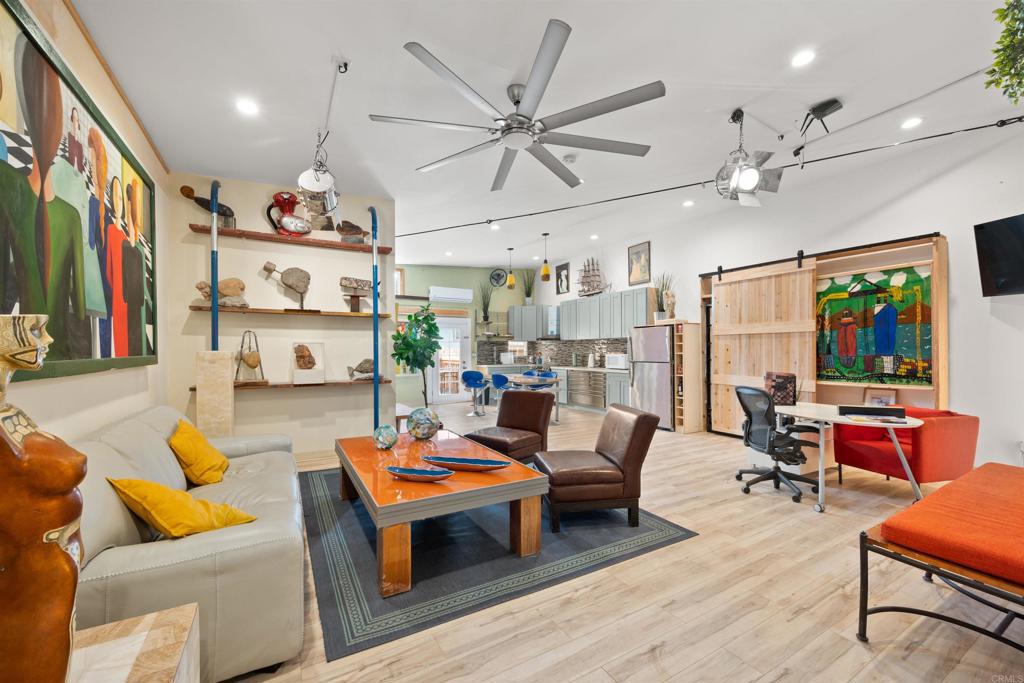 a living room with lots of furniture and a large window