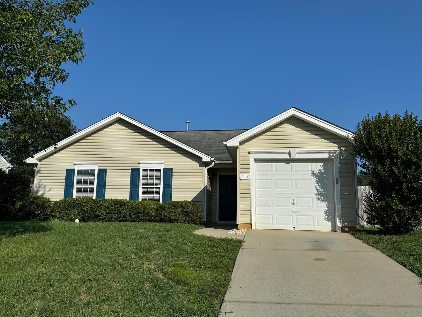 a view of a house with a yard and garage