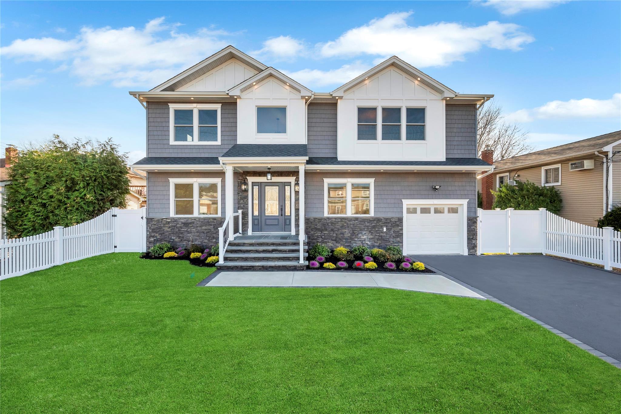 Craftsman-style house featuring a front yard and a garage