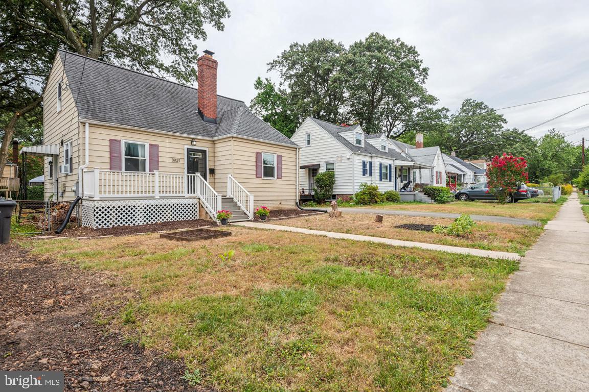 a front view of a house with a yard and trees