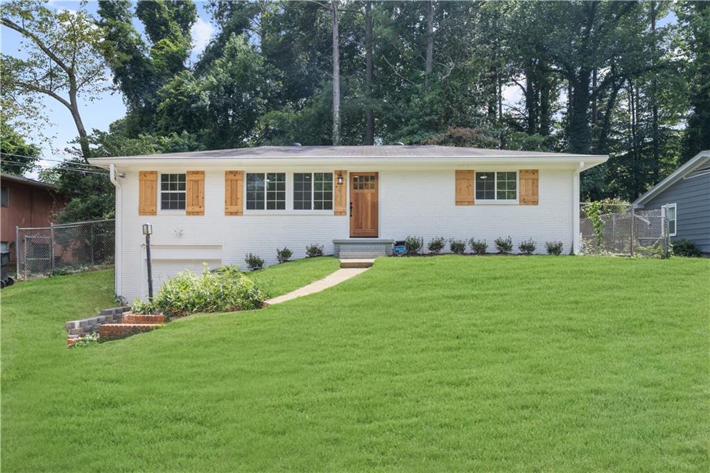 a front view of house with yard and green space