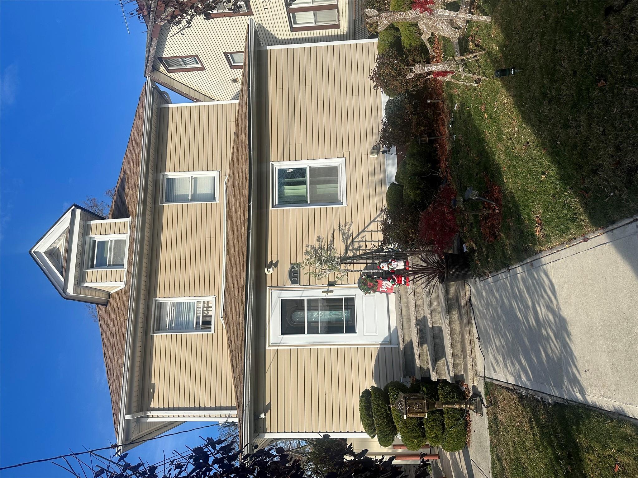 a front view of a house with a garden