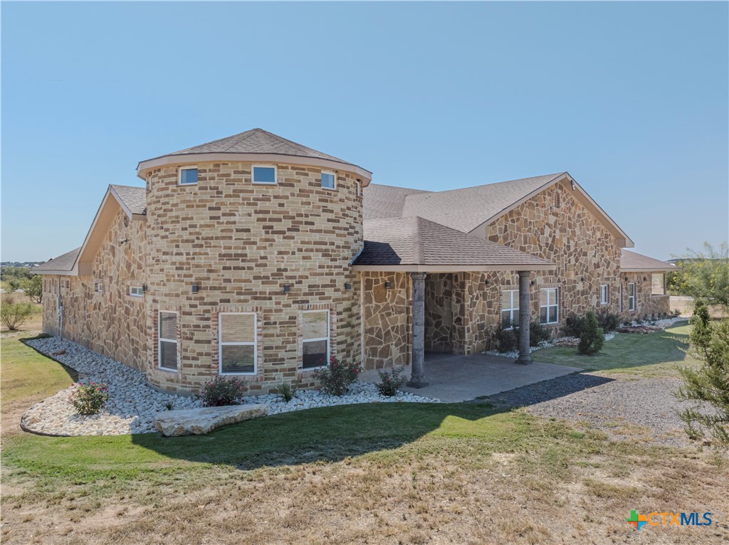 a large brick building with a yard in front of it