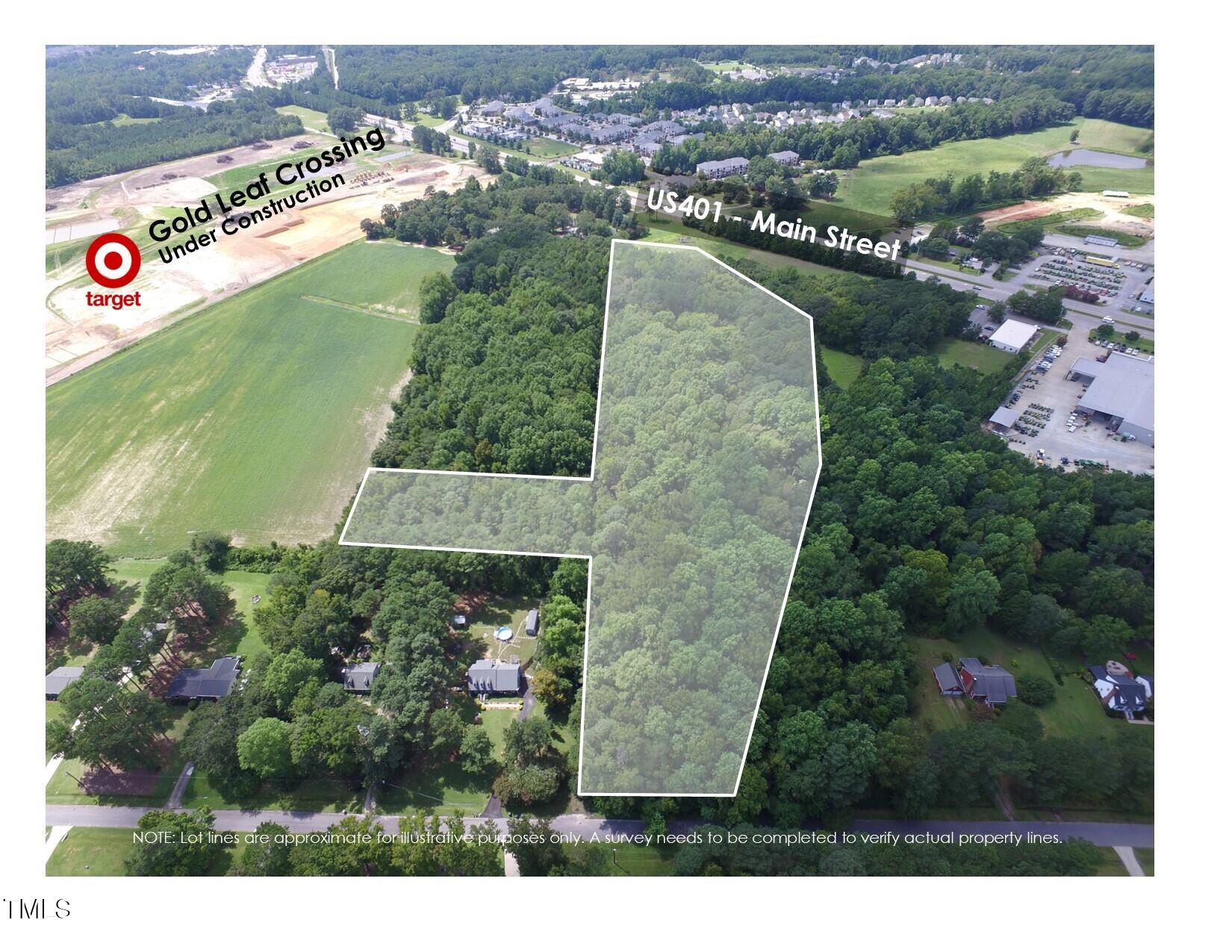 an aerial view of a house with a yard and lake view