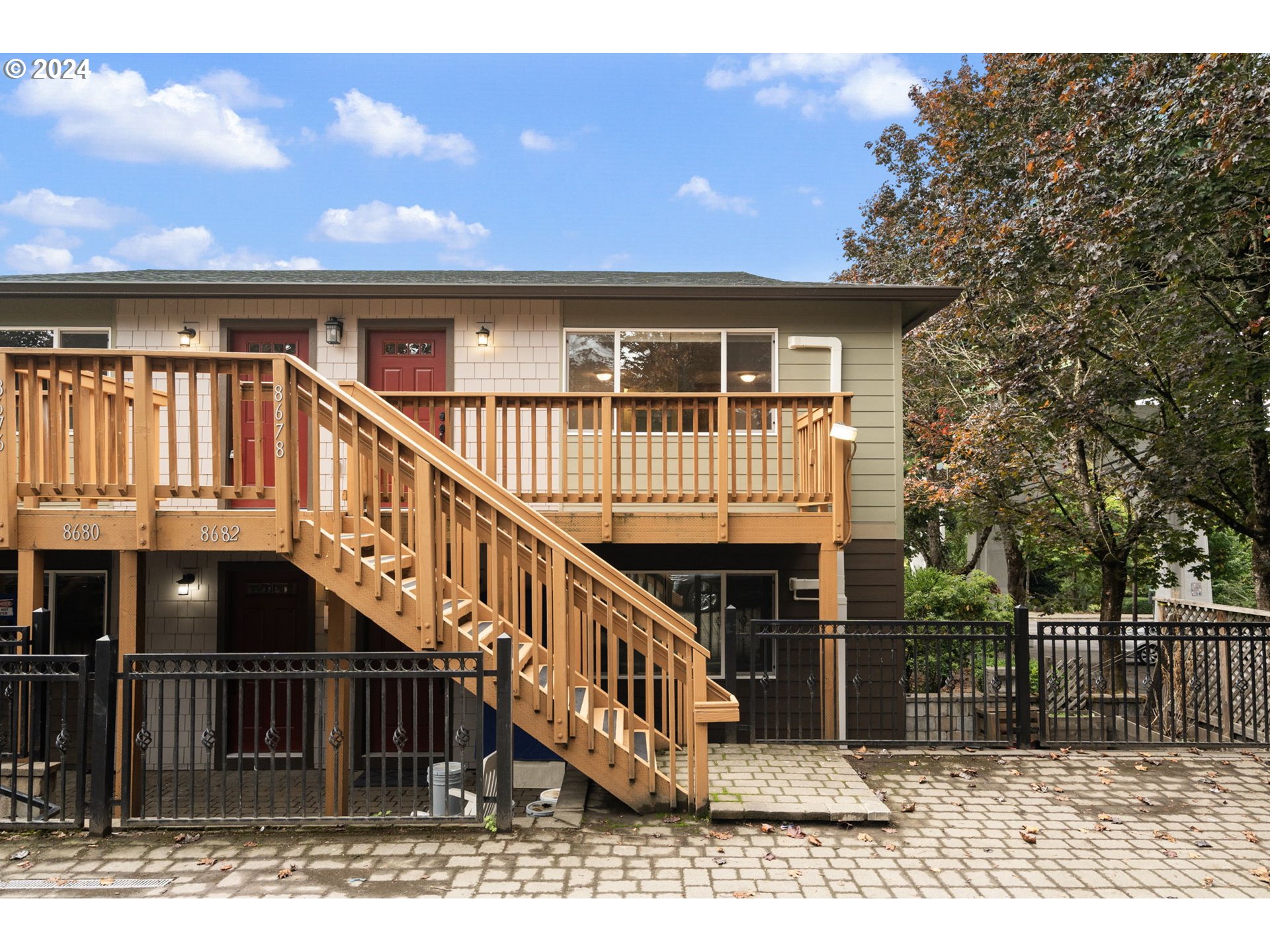 a view of house with front door and deck