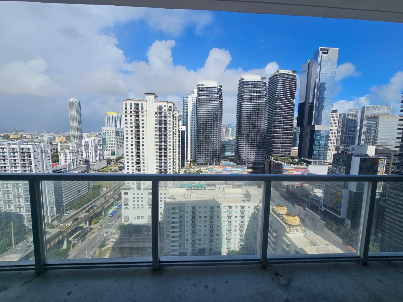 a view of swimming pool with outdoor seating and city view