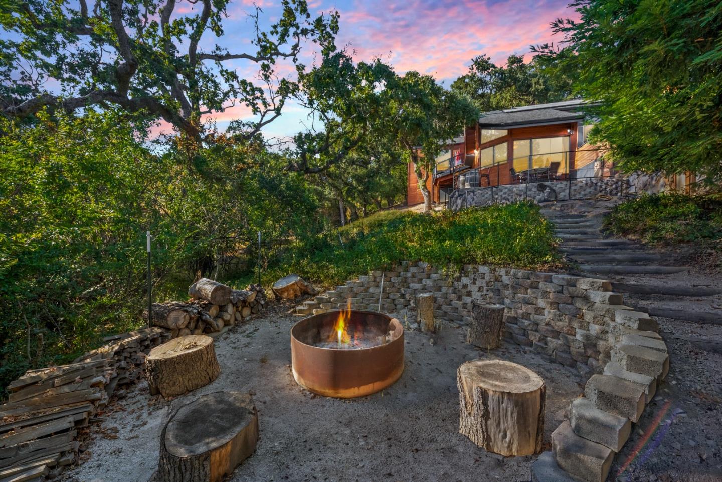 a backyard of a house with table and chairs potted plants