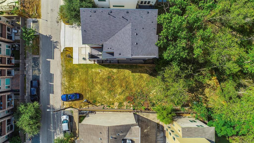 an aerial view of a house with a yard swimming pool and outdoor seating