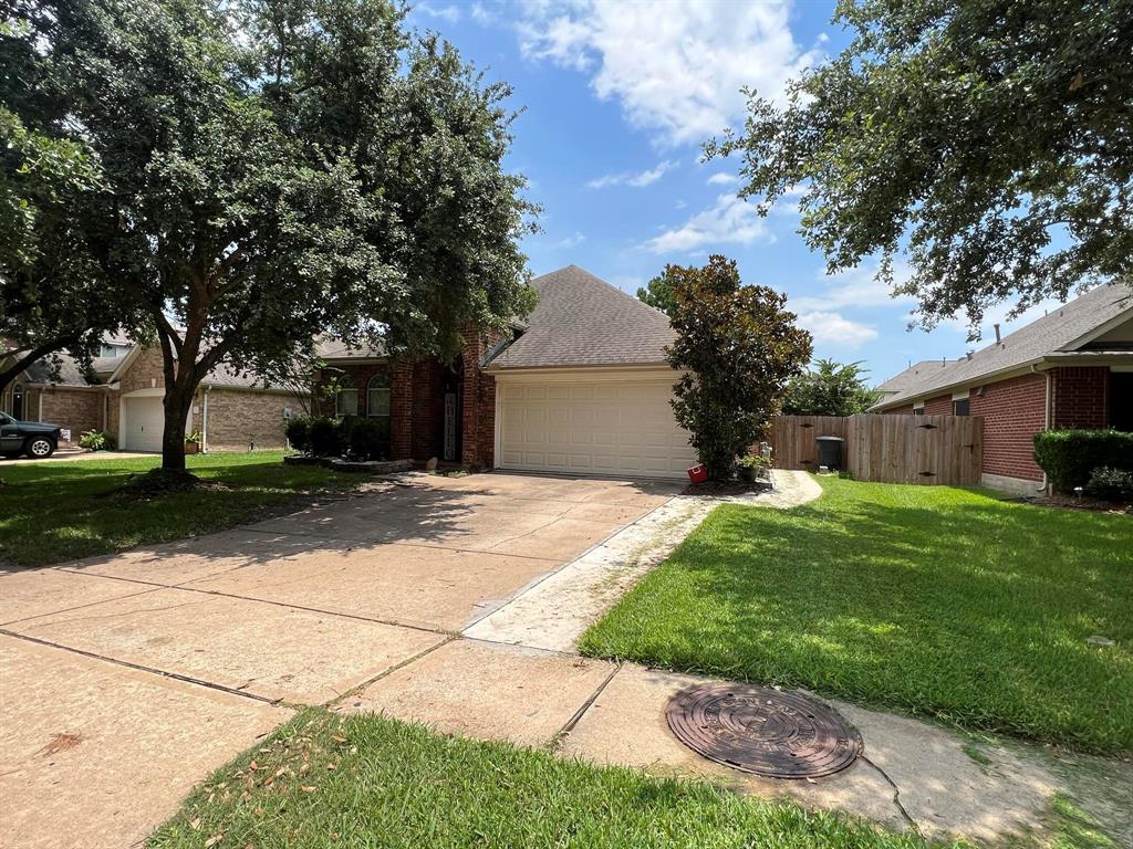 a front view of a house with a yard and a garage