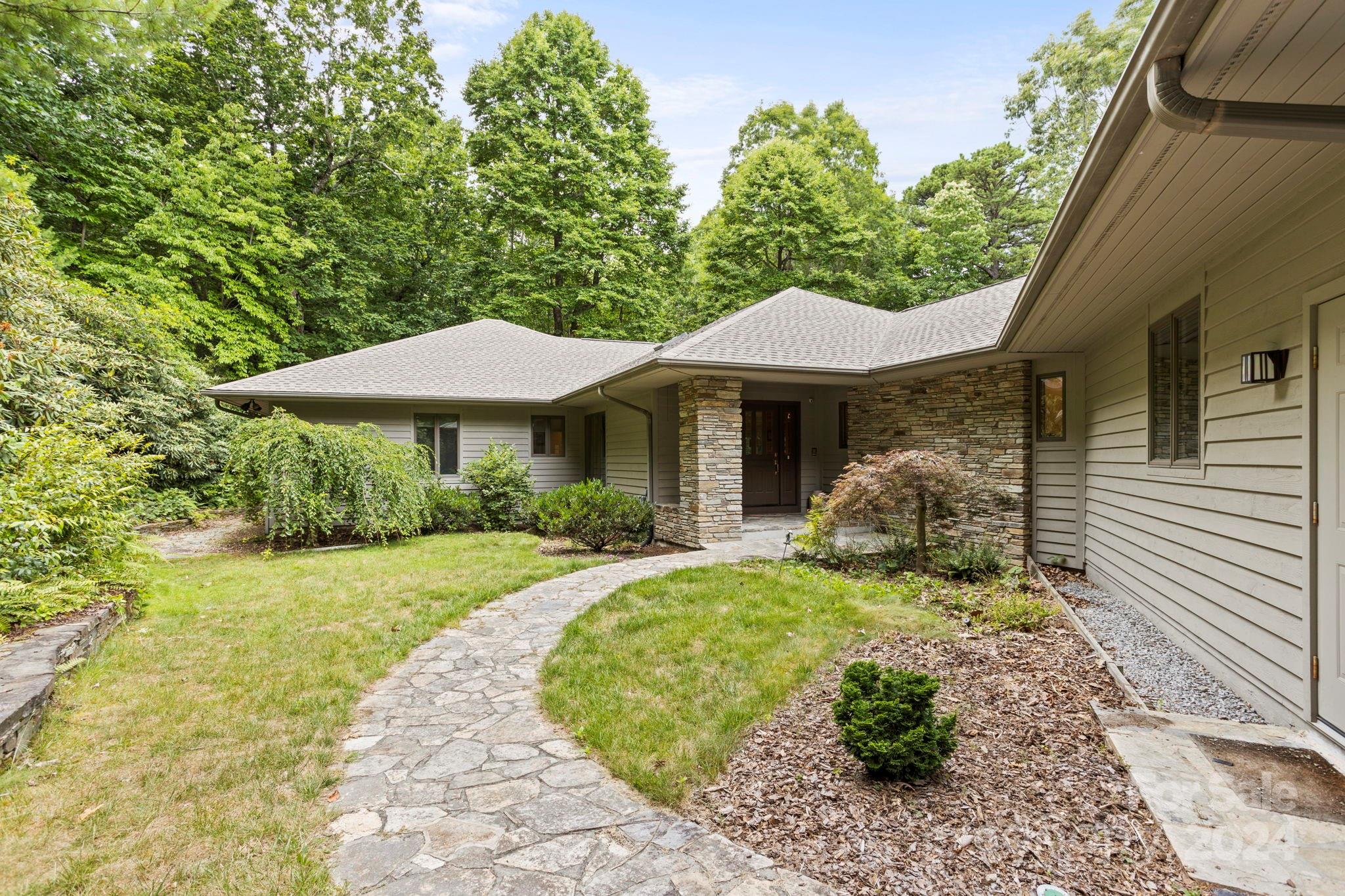 a front view of a house with garden