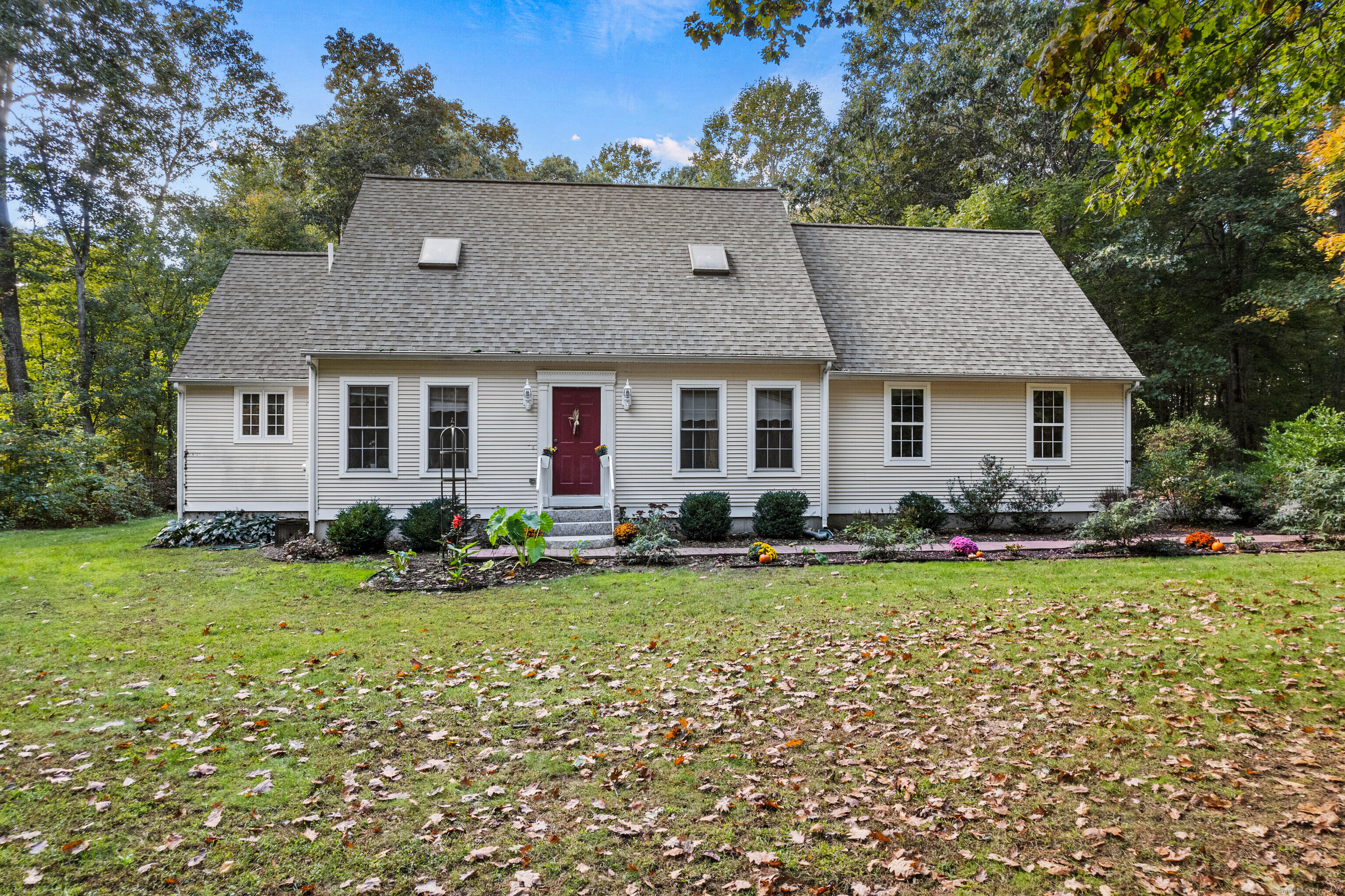 a front view of house with yard and green space