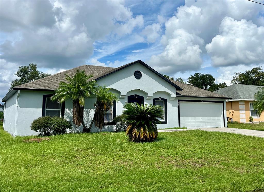 a front view of house with yard and green space