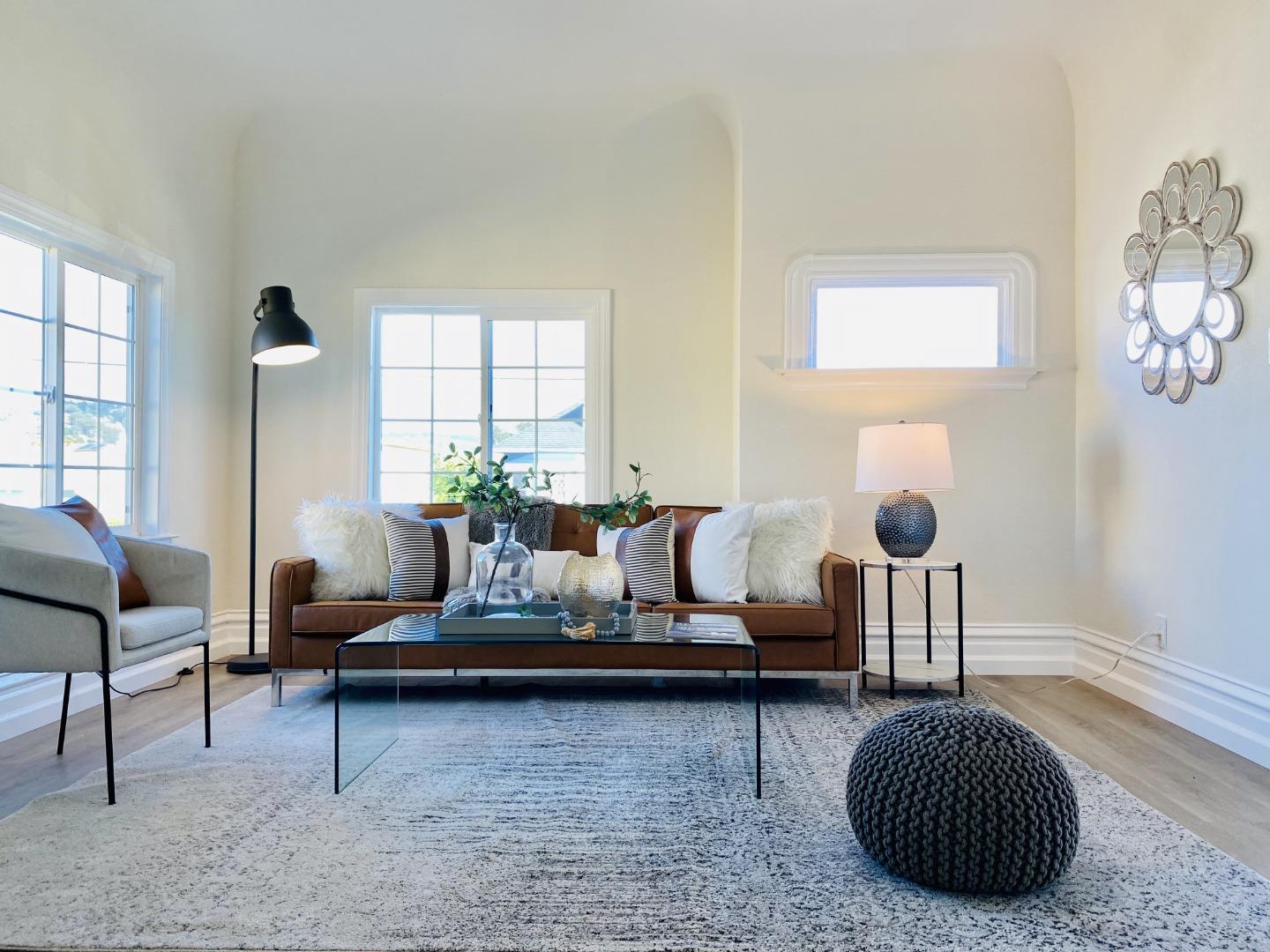 a living room with furniture and a potted plant