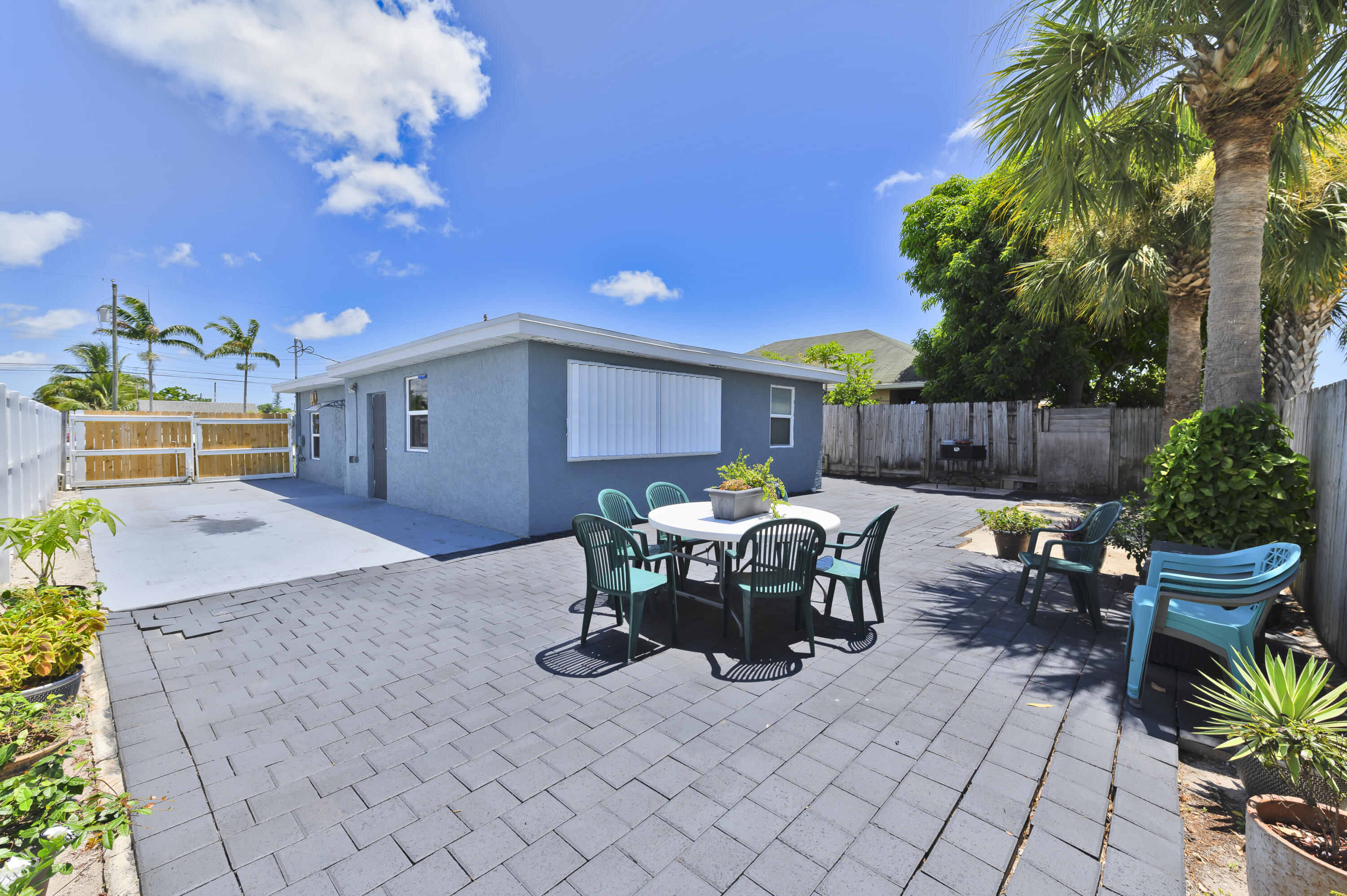 a view of a patio with table and chairs and potted plants