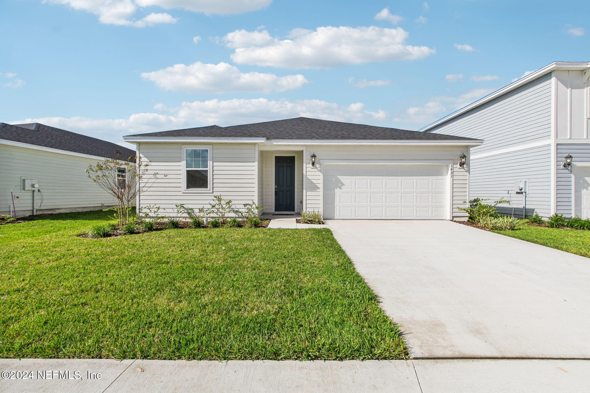 a front view of house with yard and green space