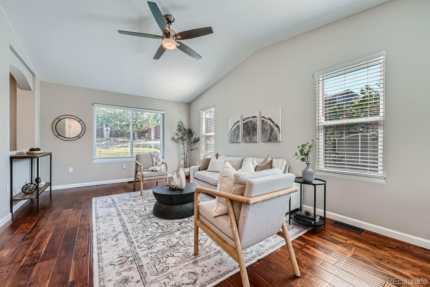 a living room with furniture a window and a table