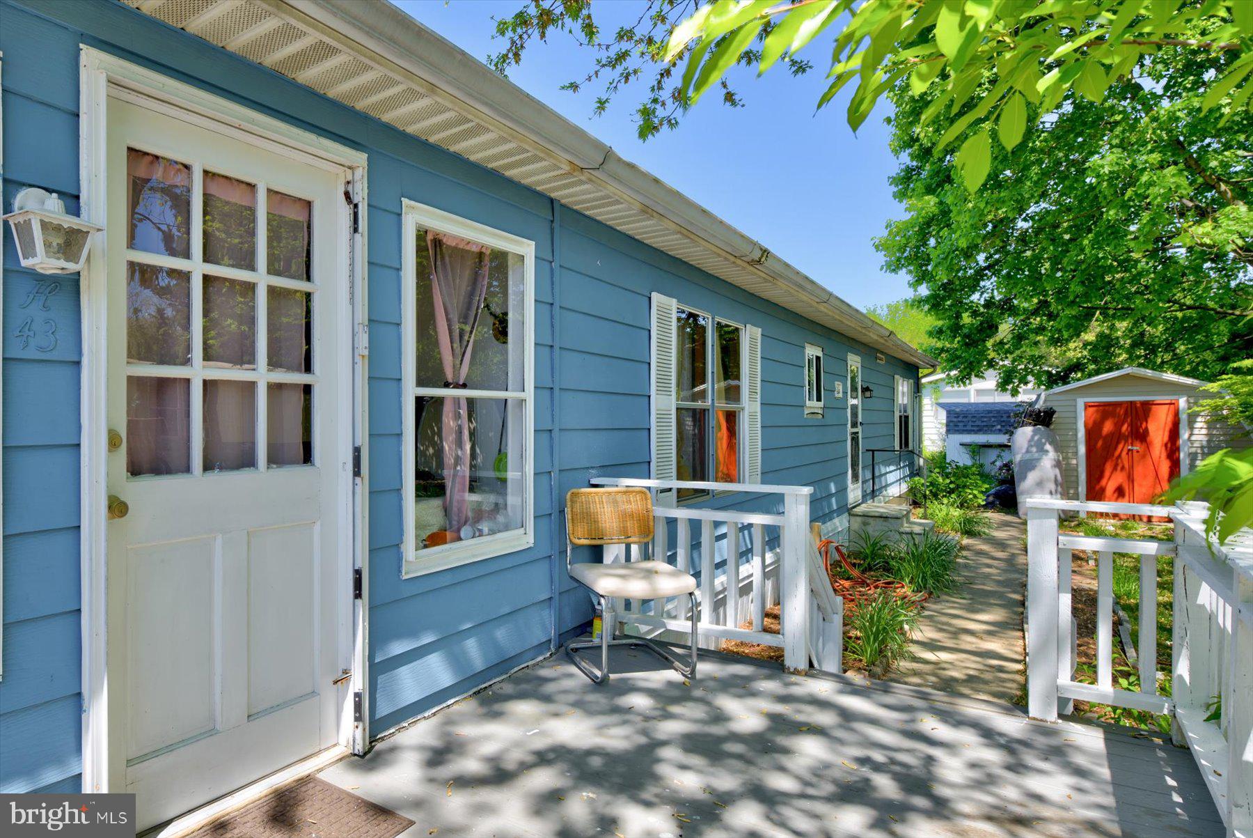 a front view of a house with outdoor seating