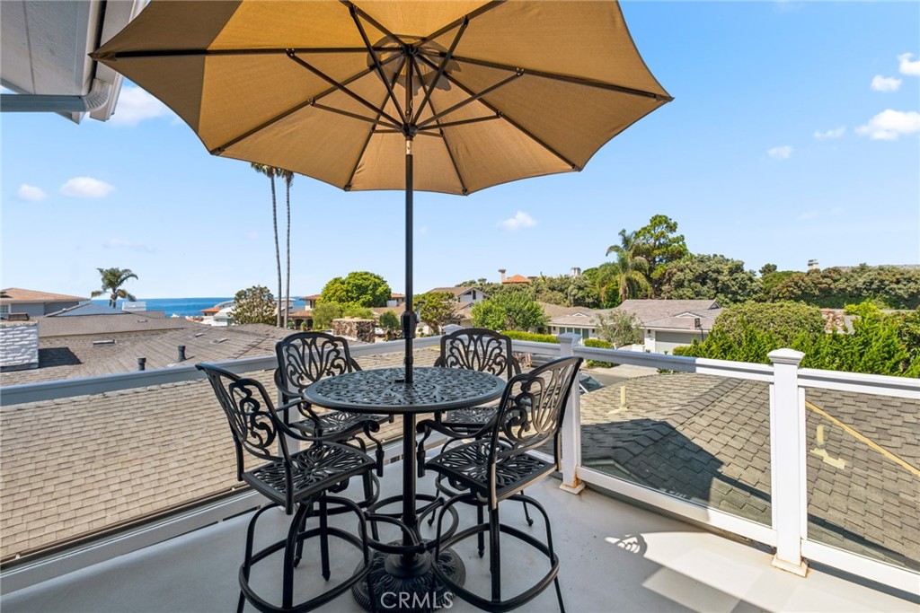 a view of balcony with furniture and umbrella