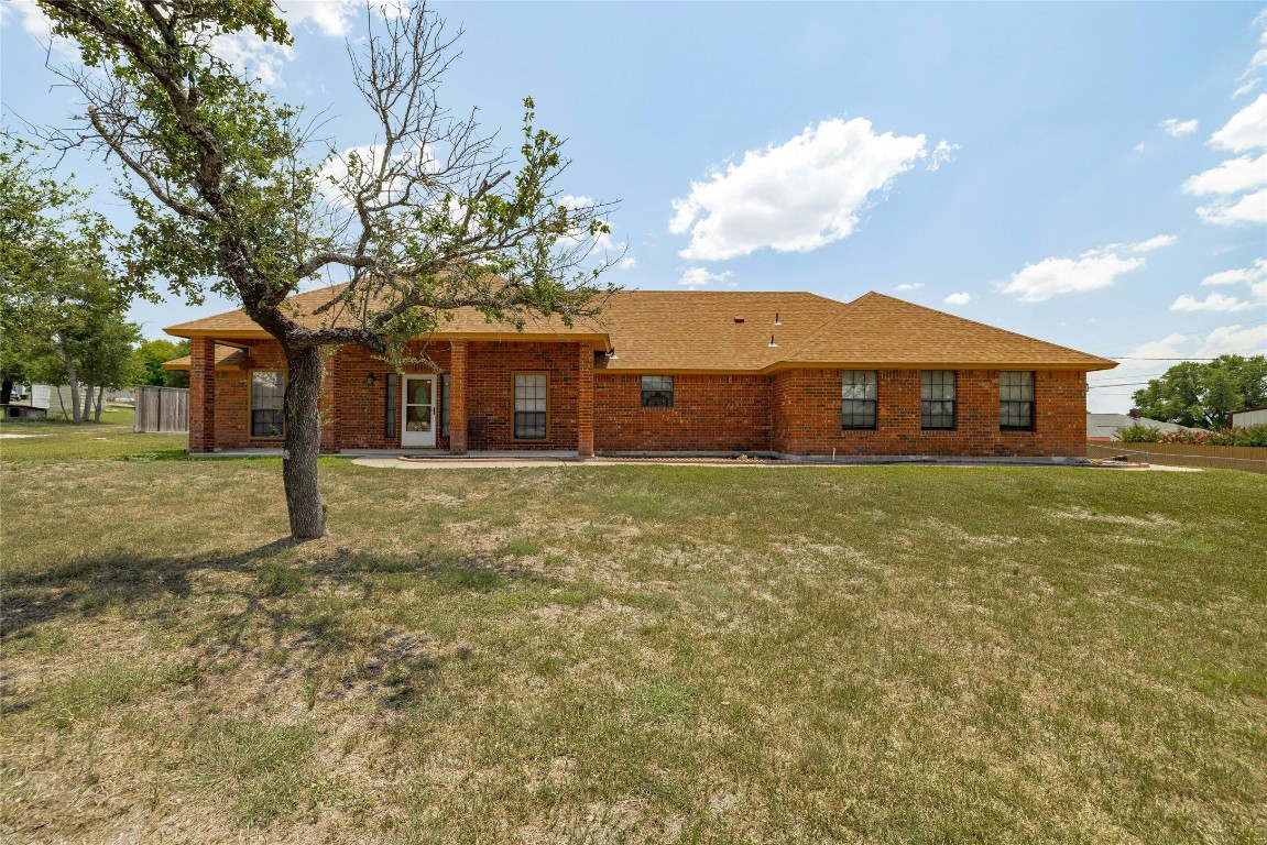 Great yard with packed aggregate driveway and concrete parking pad