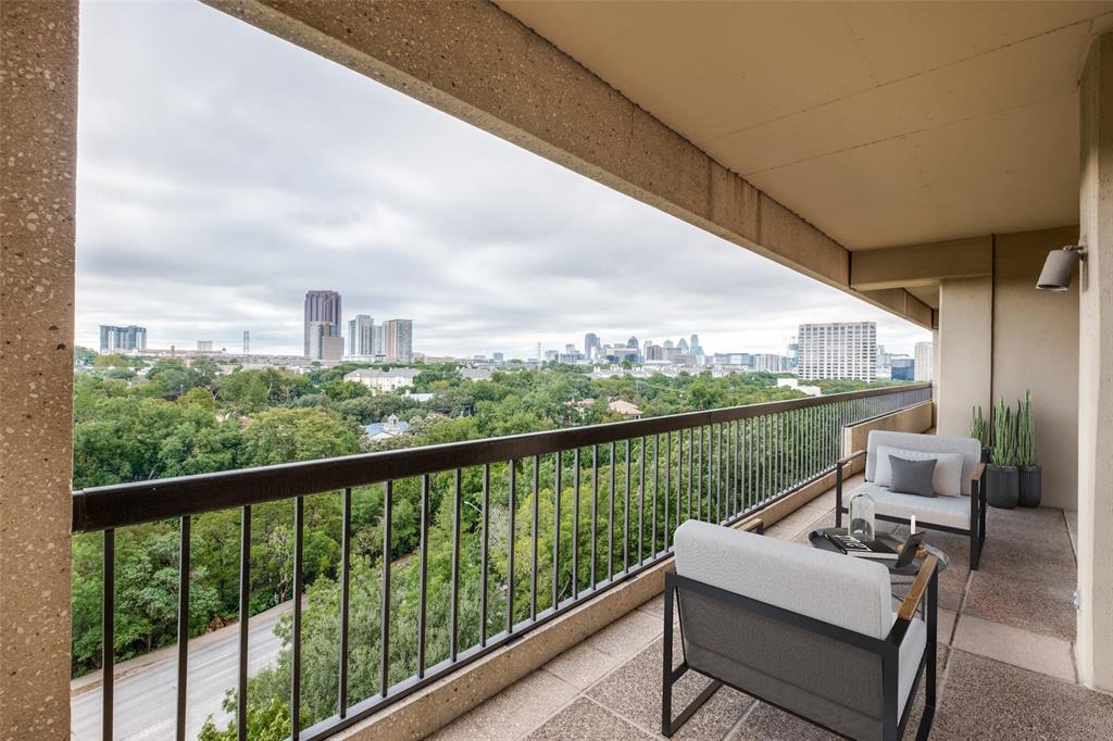 a balcony with wooden floor outdoor seating and city view