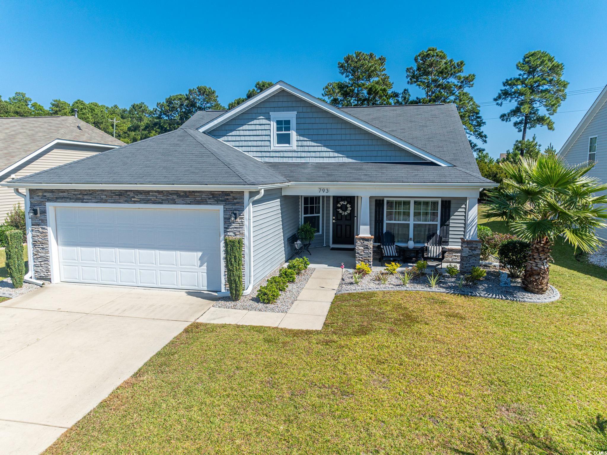 Craftsman house featuring covered porch, a front y