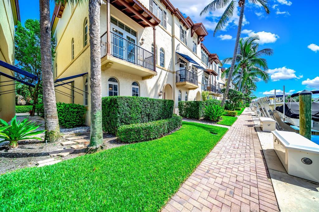 a view of a building with a yard and plants